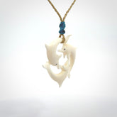 Hand carved dolphin trio pendant, made from natural bone by NZ Pacific. Hand made natural bone dolphin trilogy necklace, provided with an adjustable cord